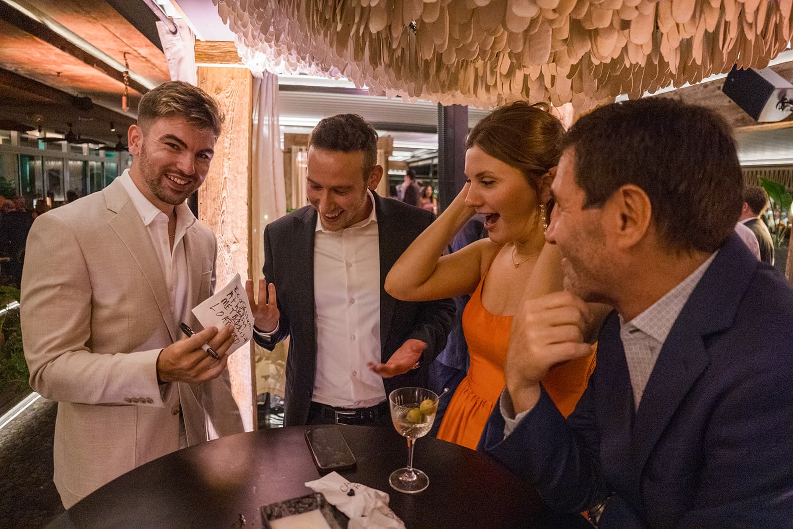 Guests reacting to Edwin's mentalism at a corporate Christmas party